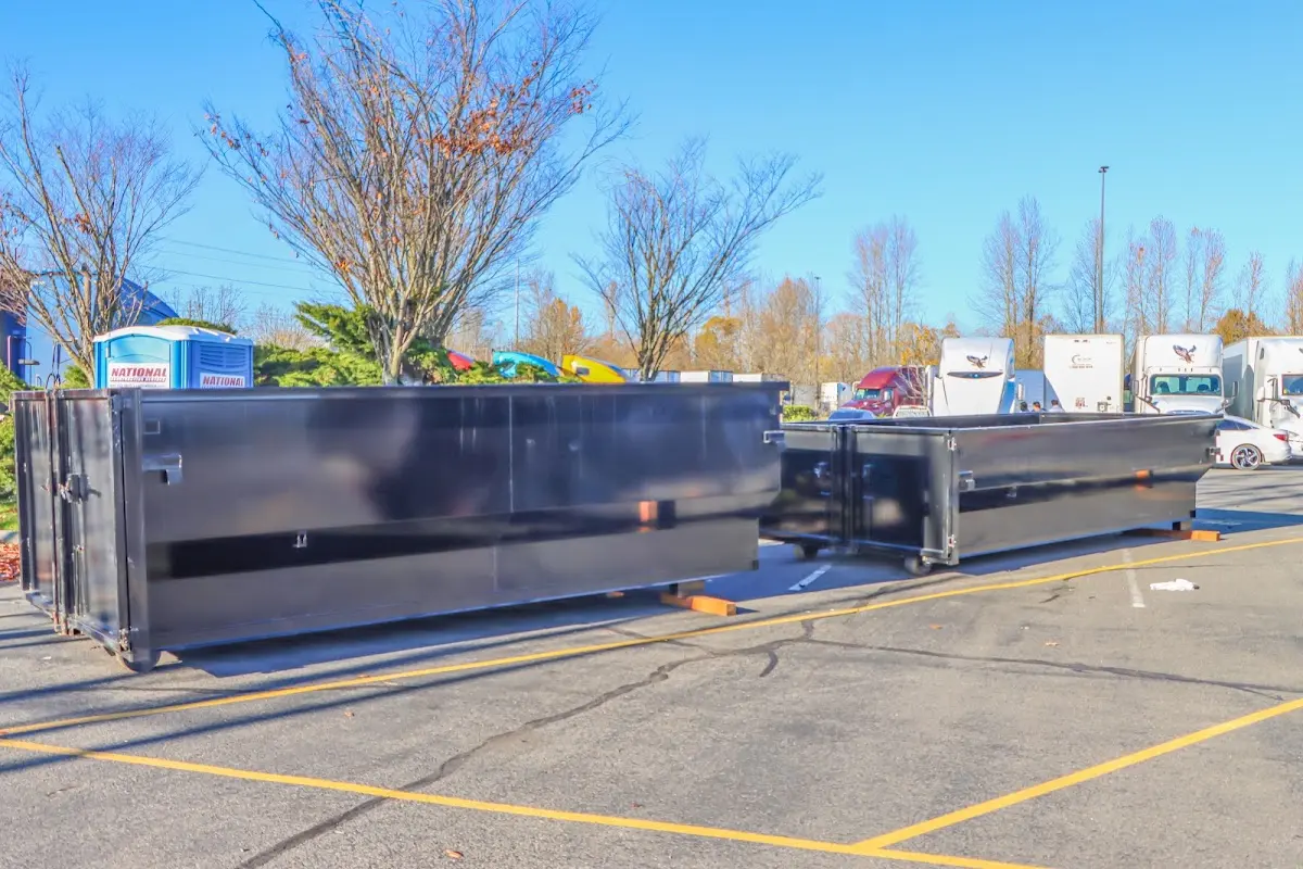 Professional dumpster rental service with roll-off container on residential driveway in Simsbury